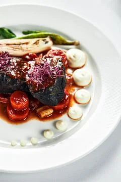 Braised beef cheeks with vegetables, cooking beef cheeks in red wine sauce with Stock Photos