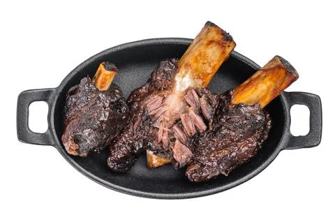 Braised beef ribs with pulled texture and caramelized surface in skillet. S.. Stock Photos