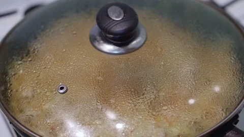 Braised cabbage is cooked in a skillet under the glass lid Stock Footage 102035124