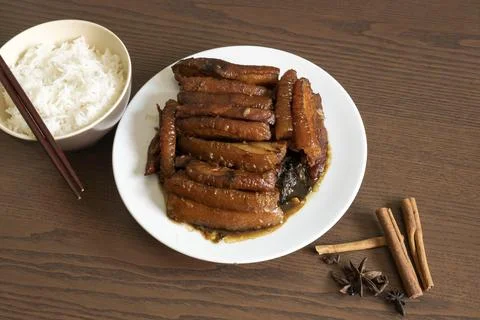 Braised Pork Belly with Pickled Cabbage and Steamed Rice on Wooden Table Stock Photos