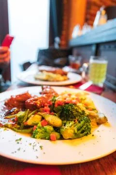 Braised rabbit in dark beer with mashed potatoes and steamed vegetables Stock Photos