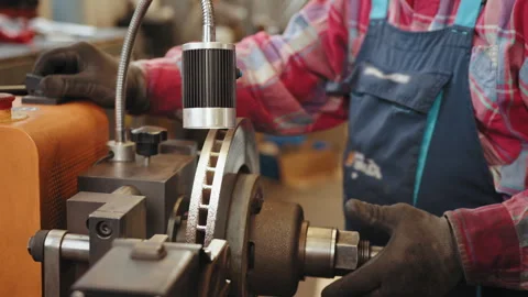 Brake disc rotor resurfacing services in garage shop. Car brake repairing in Stock Footage 243715647