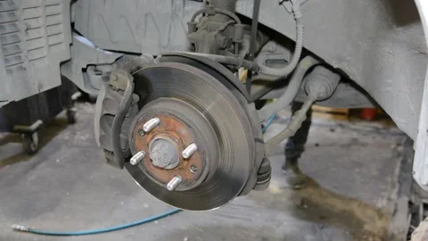Brake disk of the car. Maintenance in the car service. Repair of the brake mecha Stockbeeldmateriaal 133559127