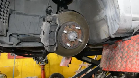 Brake disk of the car. Maintenance in the car service. Repair of the brake mecha 스톡 동영상 133559236