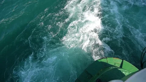 Braking a ferry in the water at the pier, reverse thrust of the propeller with Stock Footage 264094969