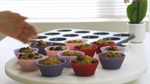 Bran muffins with dry cranberries close up in baking silicon cups  Stock Footage 127737778