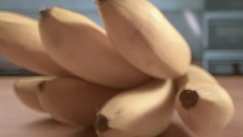 A branch of bananas on the kitchen table is not of the first freshness close-up Stock Footage 253877836
