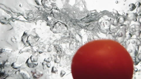 Branch with cherry tomatoes falls down into clear water 스톡 동영상 153002942