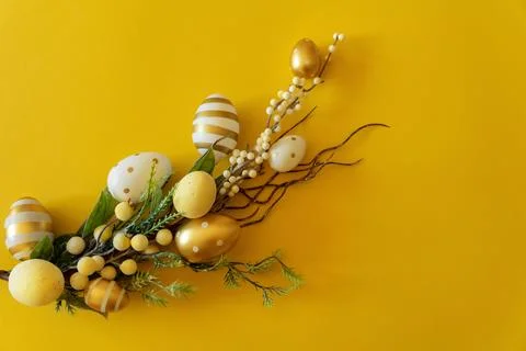 Branch with Easter eggs on a yellow background. Happy Easter with place for t Stock Photos