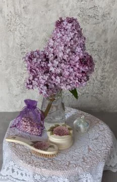 A branch of lilac on the dressing table Stock Photos