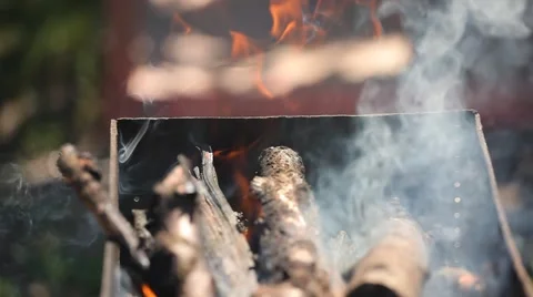 Branches of cherry wood stacked in a barbecue burning bright red flames Stock Footage 66062811