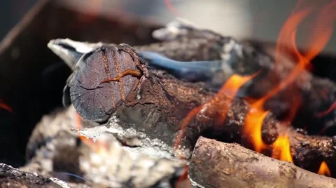 Branches of cherry wood stacked in a barbecue burning bright red flames Stock Footage 66063853