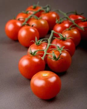 Branches with small tomatoes on the table Stock Photos