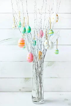 The branches of the trees decorated with multi-colored Easter eggs Stock Photos