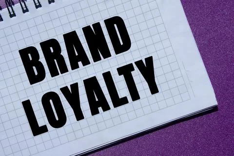 Brand loyalty message written on notebook page on purple background. Concep.. Stock Photos