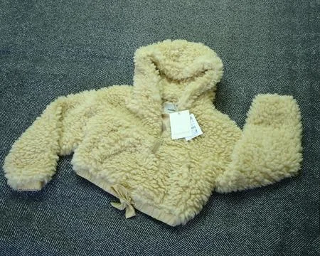 Brand name Pull Bear on a Teddy bear jacket or Sherpa hoodie. Stock Photos