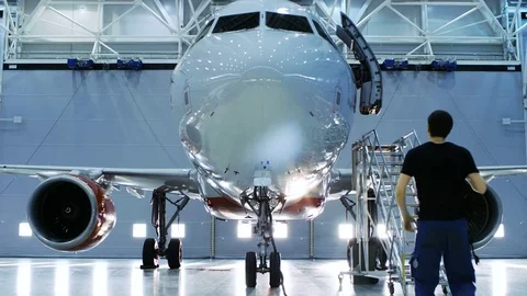  Brand New Airplane Standing in a Aircraft Maintenance Hangar, Mechanic Works Stock Footage