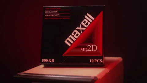 Brand new pack of Maxell floppy disks on top of a floppy drive. Stock Footage 242254760