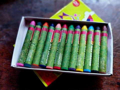 A brand new wax crayon box with all the colors in place Stock Photos