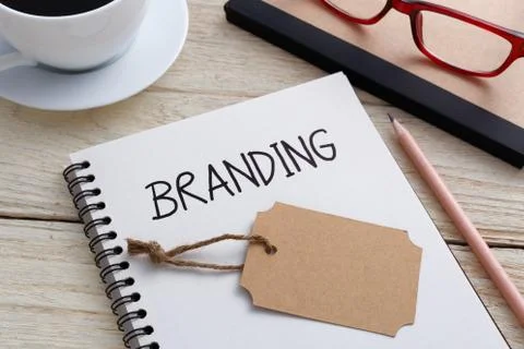 Branding concept with notebook and brand tag on work desk 库存照片