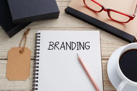 Branding concept with notebook, brand tag and product box and coffee on work  Stock Photos