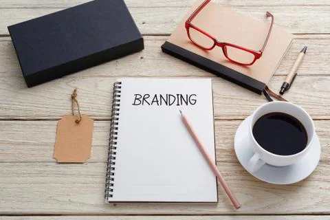 Branding concept with notebook, brand tag, product box , glasses and coffee c Stock Photos