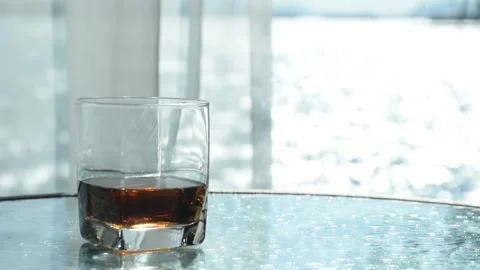 Brandy in a beautiful glass is placed Stock Footage 164162955