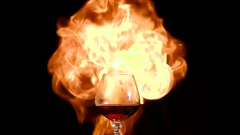 Brandy, cognac glass in fire background... | Stock Video | Pond5