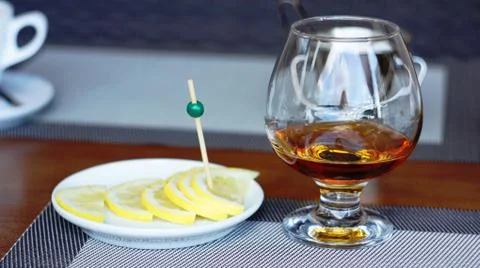 Brandy with lemon. Stock Photos