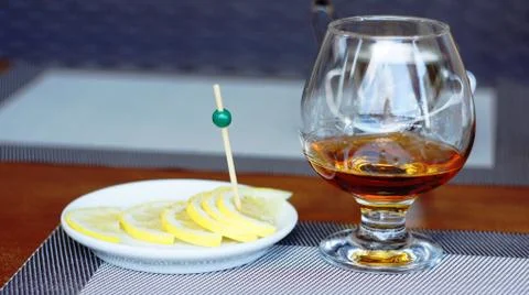 Brandy with lemon. Stock Photos