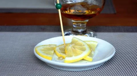 Brandy with lemon. Stock Photos
