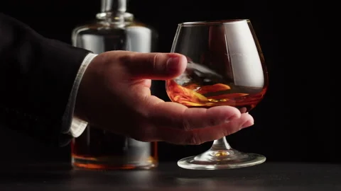 Brandy or whiskey close-up. Luxury cognac on black background. Alcohol amber Stock Footage 201945628