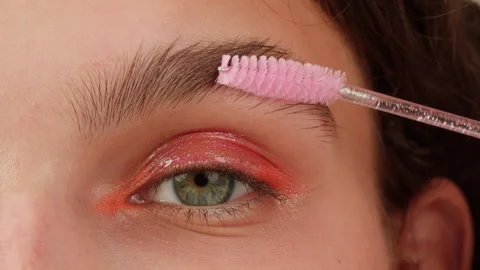 Brashing eyebrows close-up. The master makes permanent eyebrow makeup Stock-Footage 255612122
