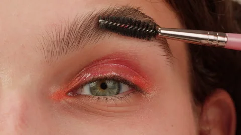 Brashing eyebrows close-up. The master makes permanent eyebrow makeup Stock-Footage 257017249