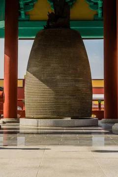 Brass bell made of tiny seated Buddhas in pavilion Stock Photos