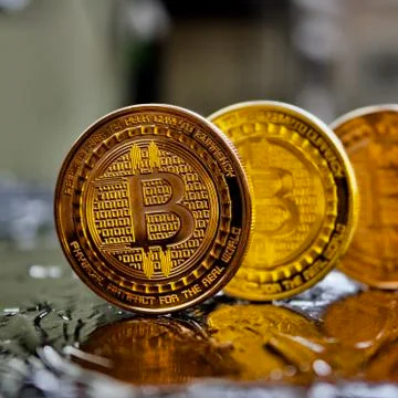 Brass bitcoin coin Stock Photos