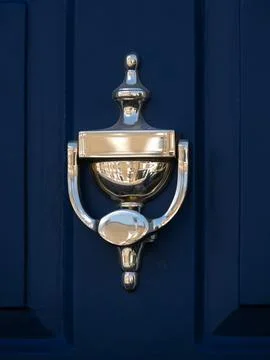 Brass door knocker with reflection of terraced Georgian houses Фото