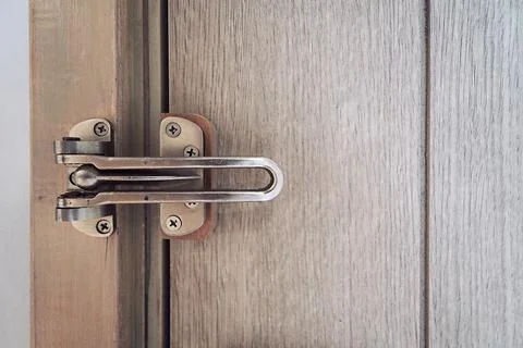 Brass Door Security Guard features a swing lock Stock Photos