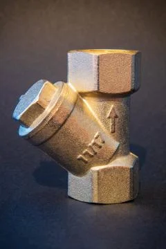 The brass filter for hot or cold water close up on dark background used in pl Stock Photos