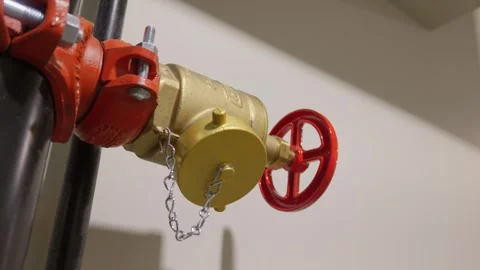 Brass fire standpipe valve with red wheel handle on indoor pipe Vídeos de archivo 335827645