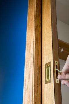 Brass handle and edge pull on a wooden pocket door Stock Photos