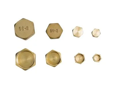 Brass hexagonal plugs in various sizes on a white background Stock Photos