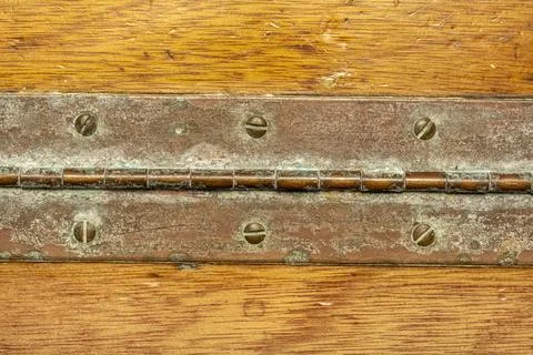 Brass hinge on teak Stock Photos