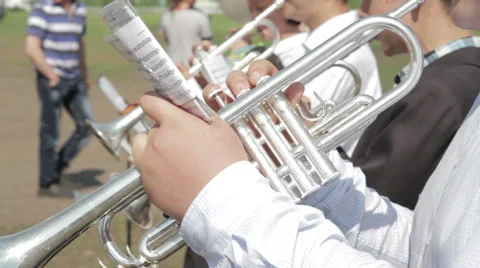 Brass instrument section of an orchestra performing outdoors Stock Footage 63547369