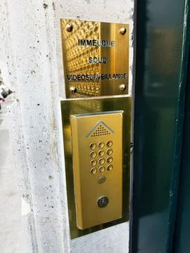 Brass intercom keypad and security entrance with video surveillance plaque .. Stock Photos
