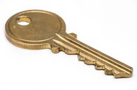 Brass key on isolated white background. Stock Photos