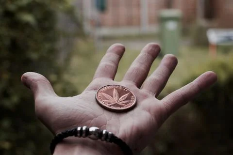Brass marijuana coin Stock Photos