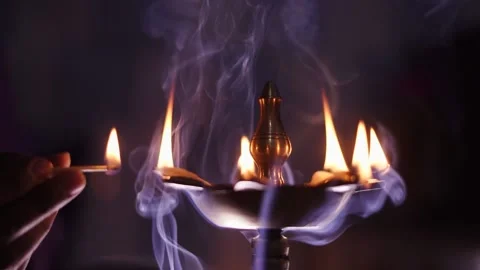 Brass oil lamp with Matchstick, Diwali decoration background, Hindu temple Stock Footage