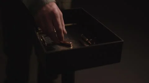Brass Rifle Cartridges and Empty Casings in a Dark Box, Moody Macro Shot Video stock 341321768