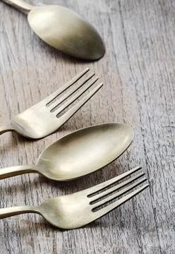 Brass spoon and fork Stock Photos